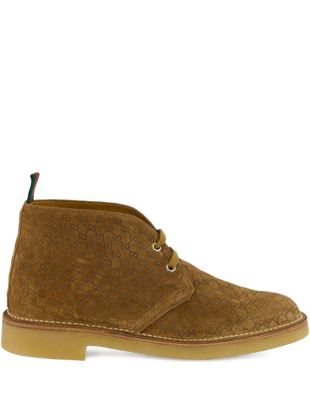 Camel suede ankle boots with all-over GG motif featuring lace-up fastening, round toe, leather lining and rubber sole. 831283 AAEYC2842 GUCCI 