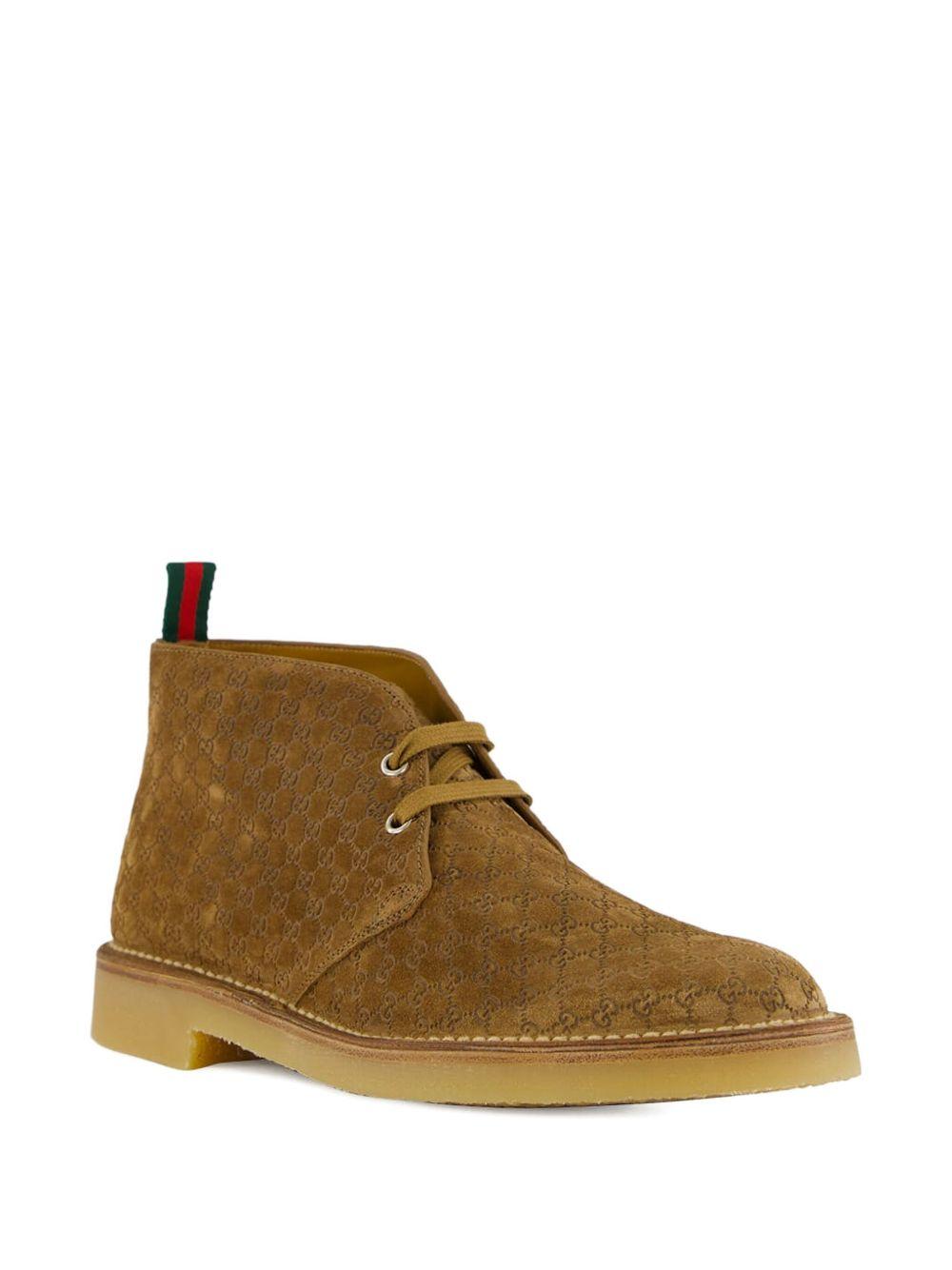 Camel suede ankle boots with all-over GG motif featuring lace-up fastening, round toe, leather lining and rubber sole. 831283 AAEYC2842 GUCCI 