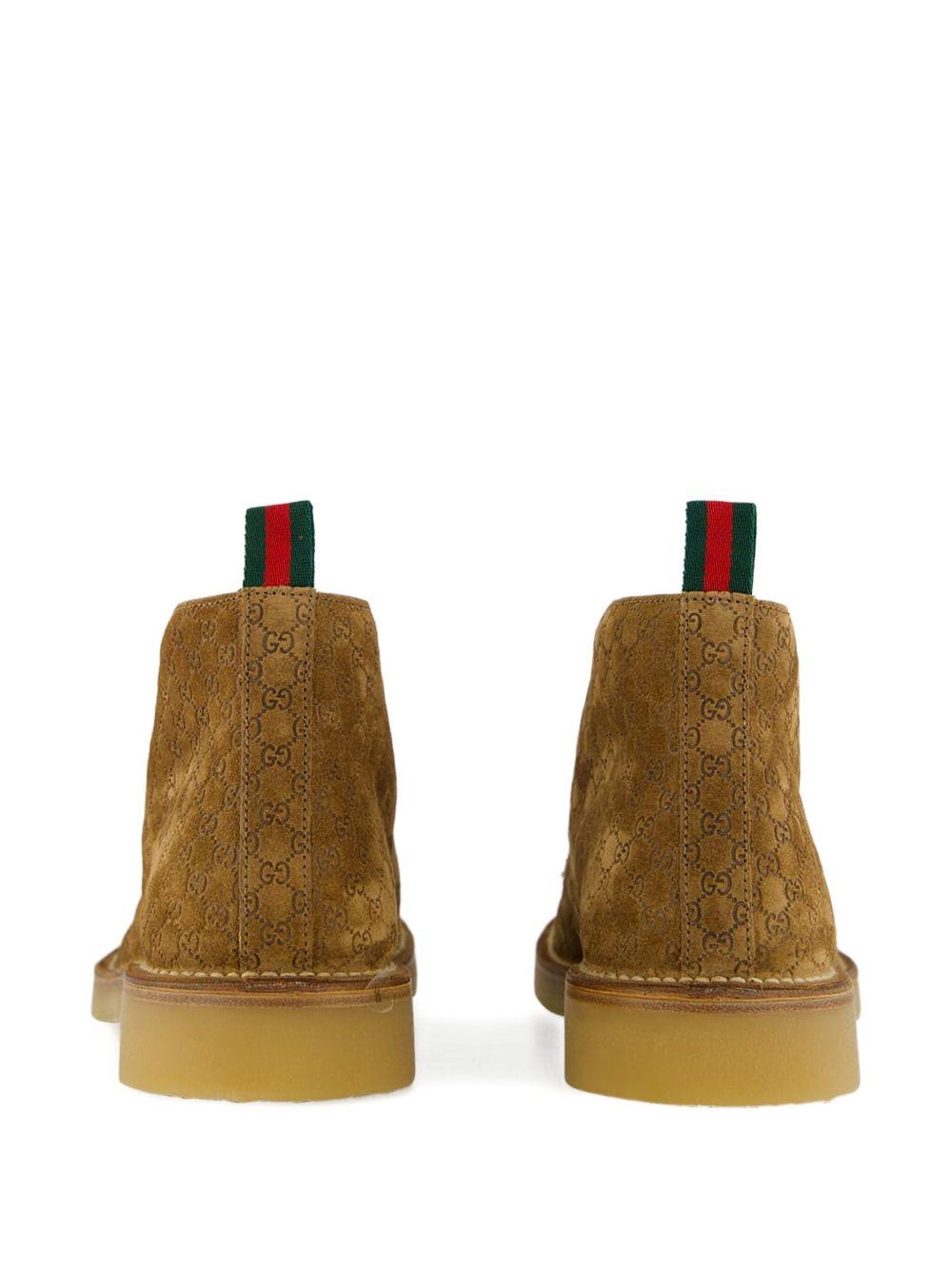 Camel suede ankle boots with all-over GG motif featuring lace-up fastening, round toe, leather lining and rubber sole. 831283 AAEYC2842 GUCCI 