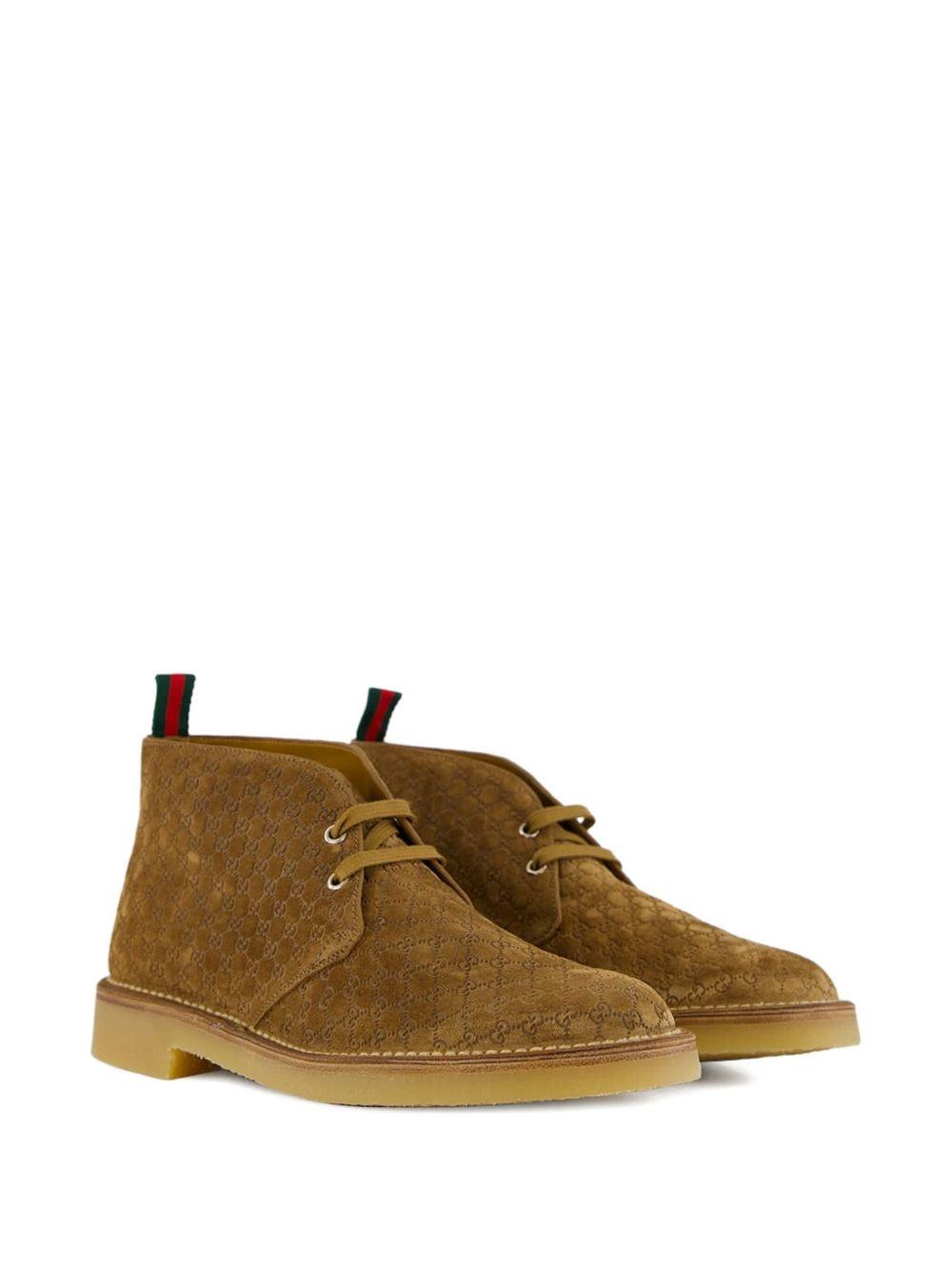 Camel suede ankle boots with all-over GG motif featuring lace-up fastening, round toe, leather lining and rubber sole. 831283 AAEYC2842 GUCCI 