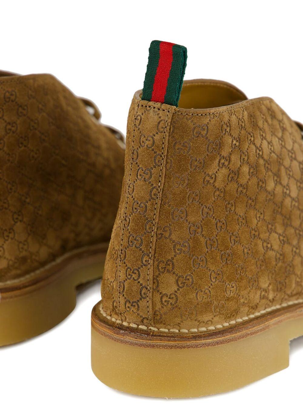 Camel suede ankle boots with all-over GG motif featuring lace-up fastening, round toe, leather lining and rubber sole. 831283 AAEYC2842 GUCCI 
